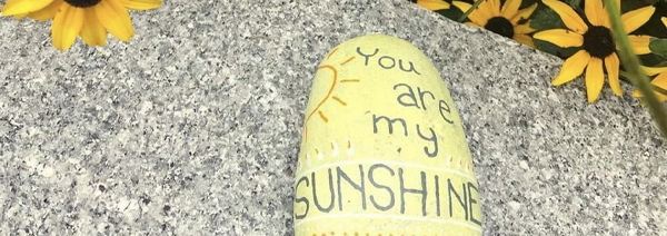 A rock painted with You are my Sunshine