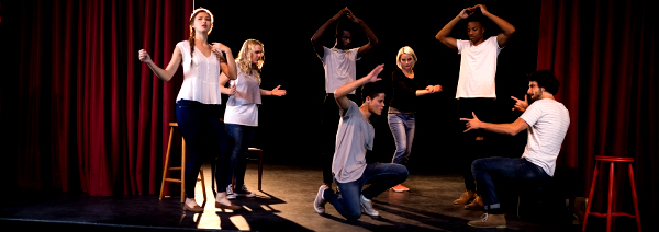 Actors practicing play on stage