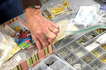 Osher member selecting beads