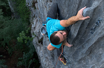 Man climbing up a rock face