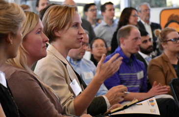 Audience members ask questions of presenting company founders.