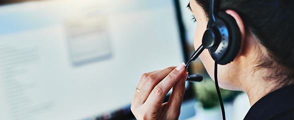 Woman with headset on computer